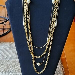 Goldtone multi strand chains and pearls layered look necklace.